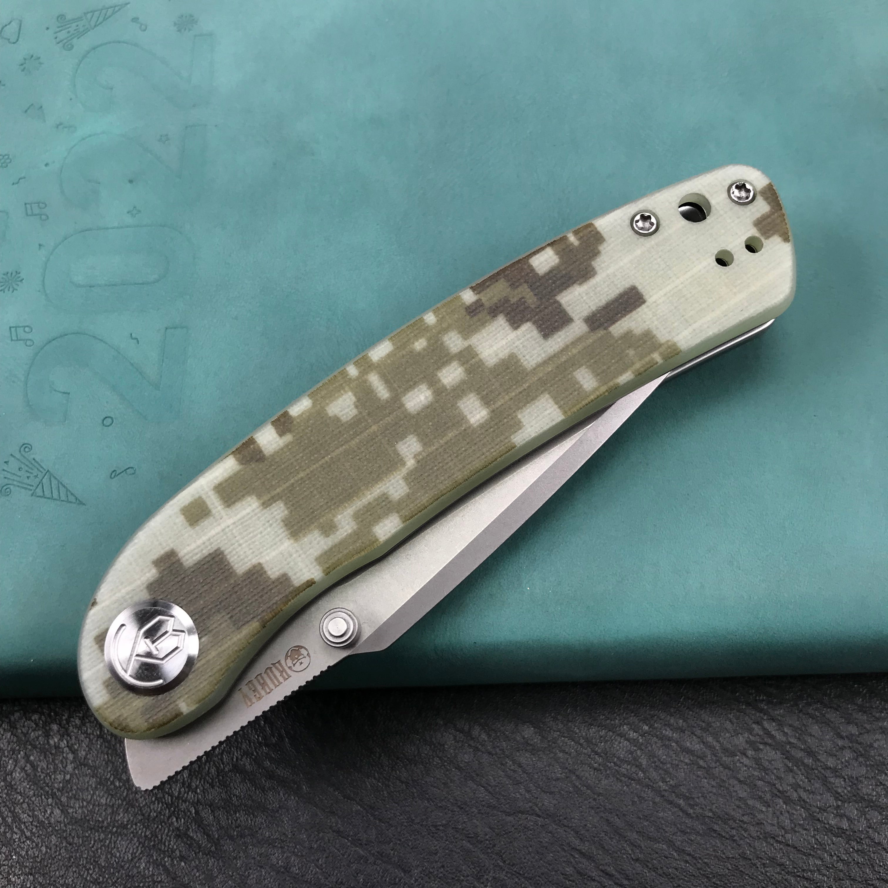 KUBEY KU344K Momentum Sherif Manganas Design Liner Lock Front Flipper / Dual Studs Open Folding Knife Digtal Camo G10 Handle 3.43" Bead Blasted AUS-10